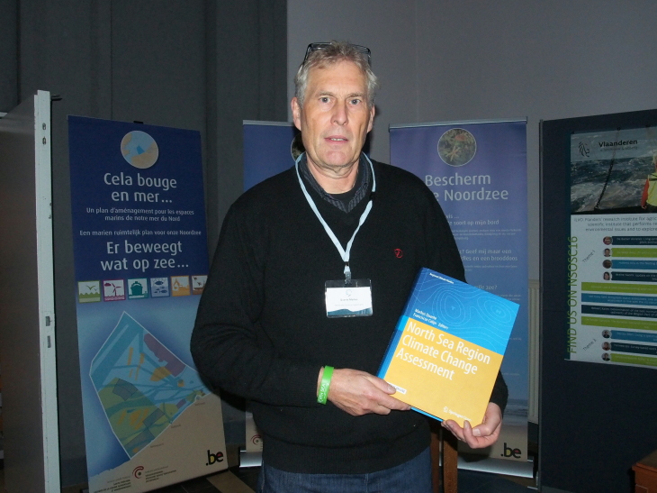 Prof. Dr. Markus Quante with the newly published book of the NOSCCA North Sea Climate Report 